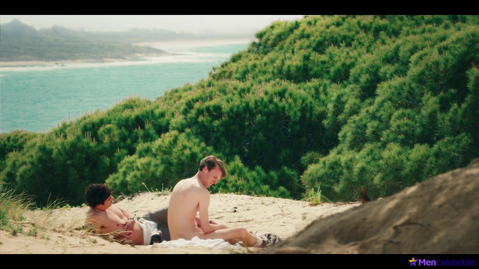 Hugh Skinner nude on a beach