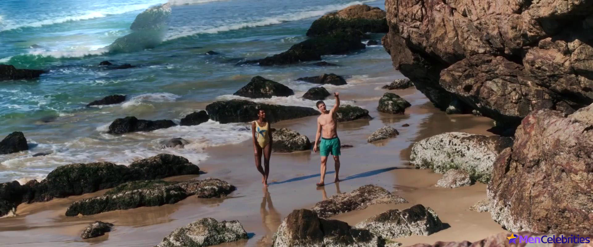 Patrick Gibson on a beach