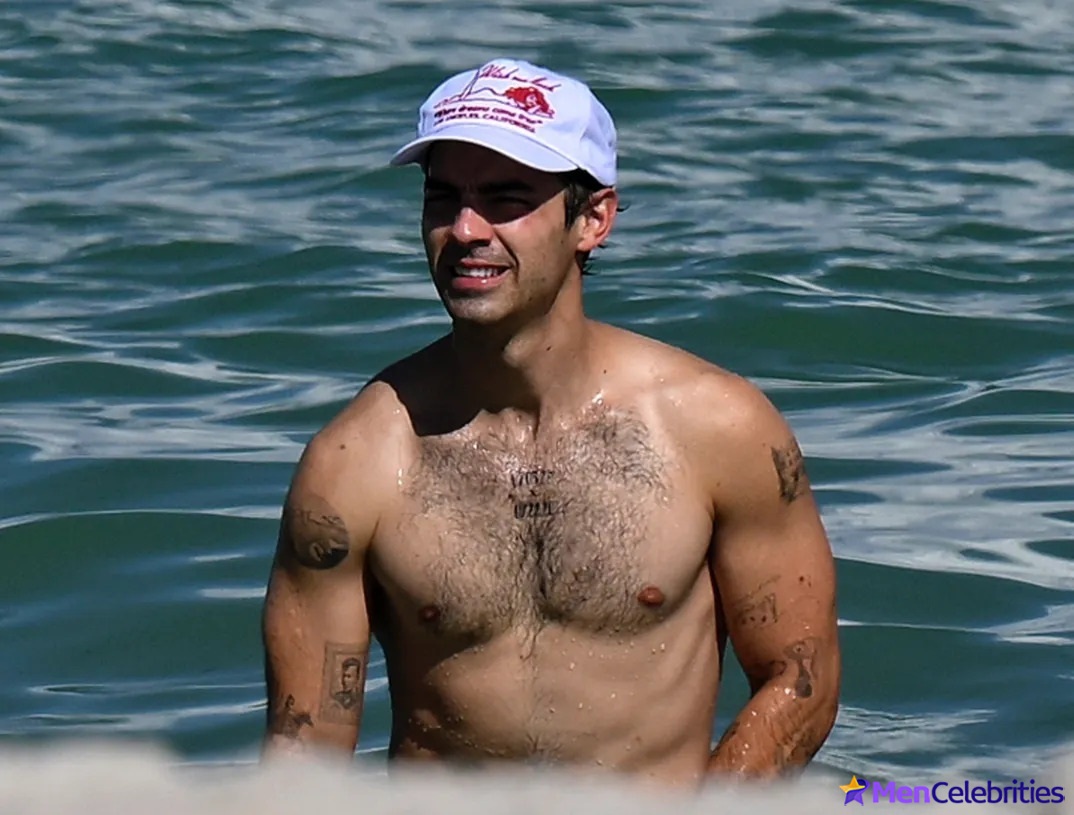 Joe Jonas shirtless on a beach