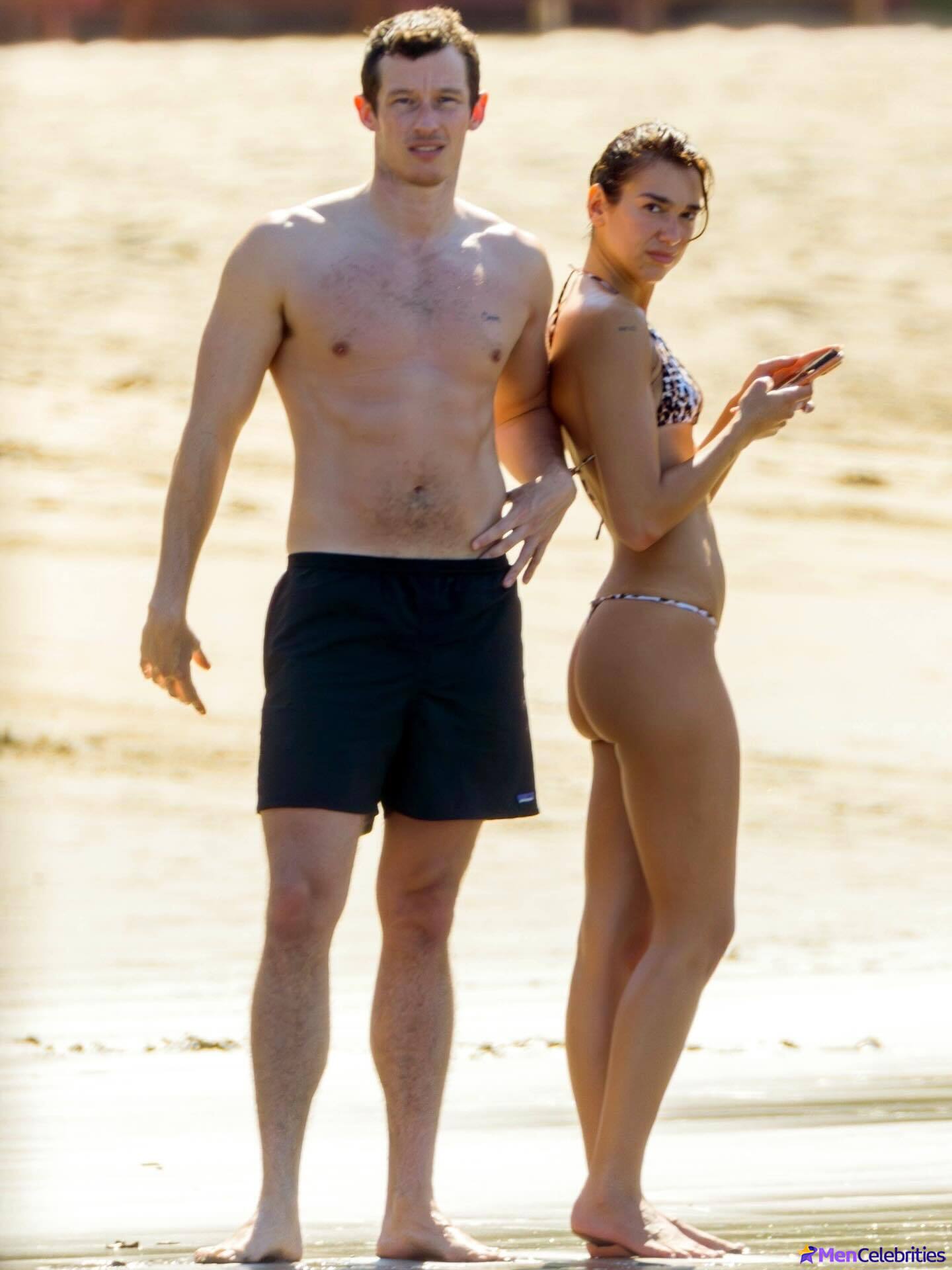 Callum Turner shirtless on beach