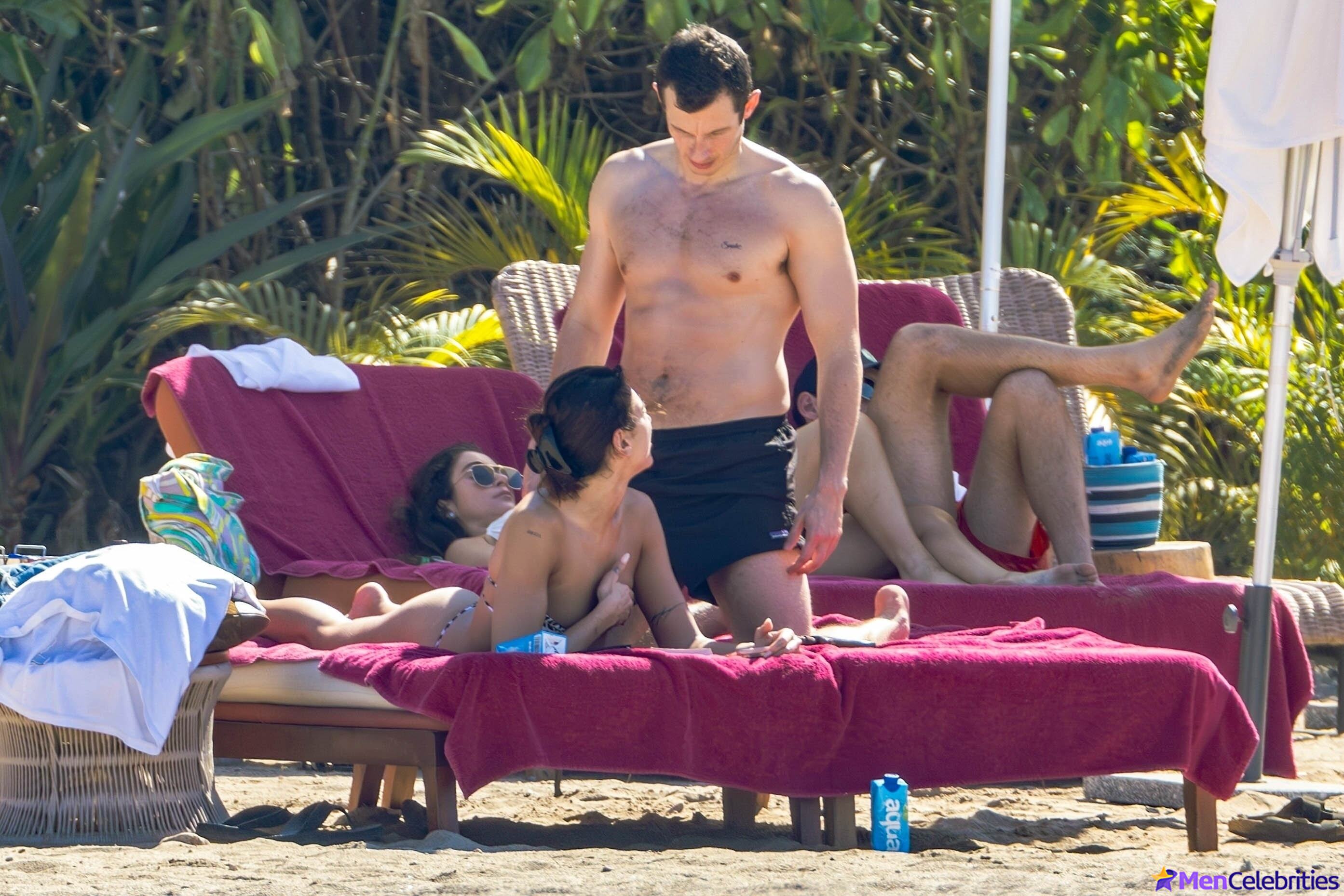 Callum Turner shirtless on beach