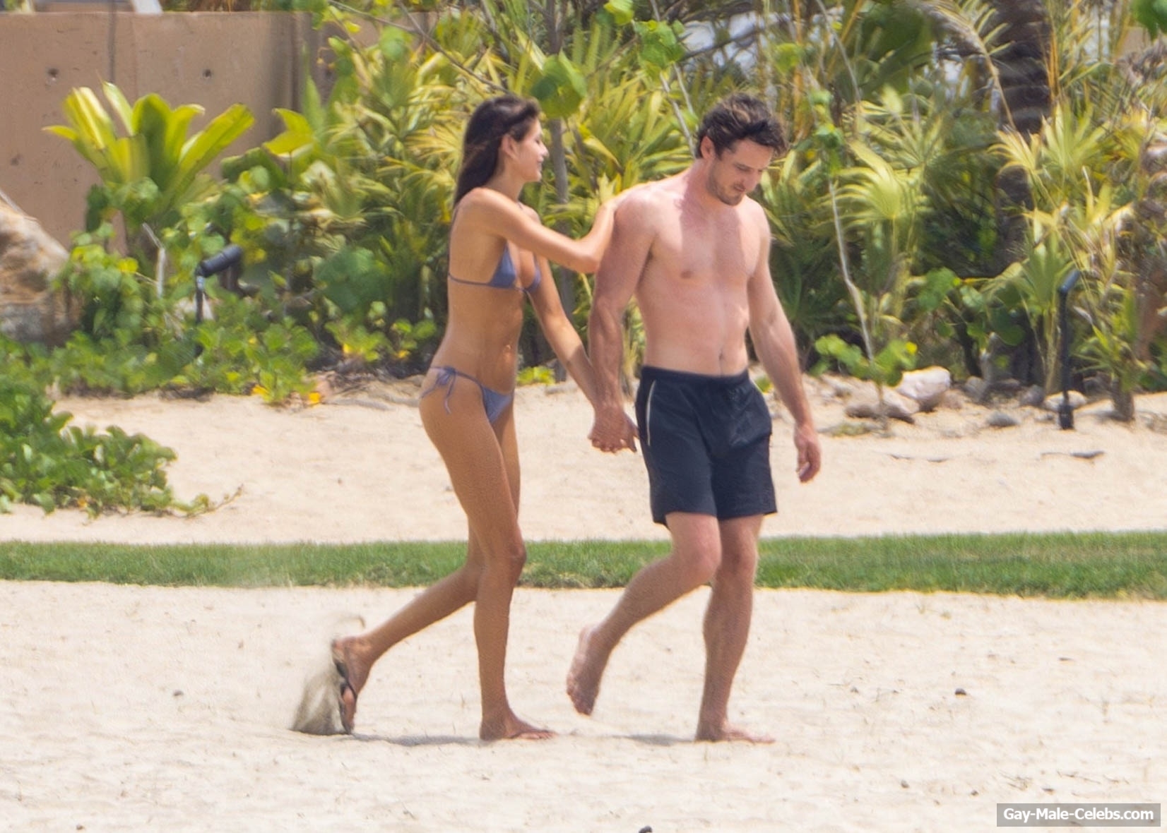 Lewis Pullman shirtless on a beach