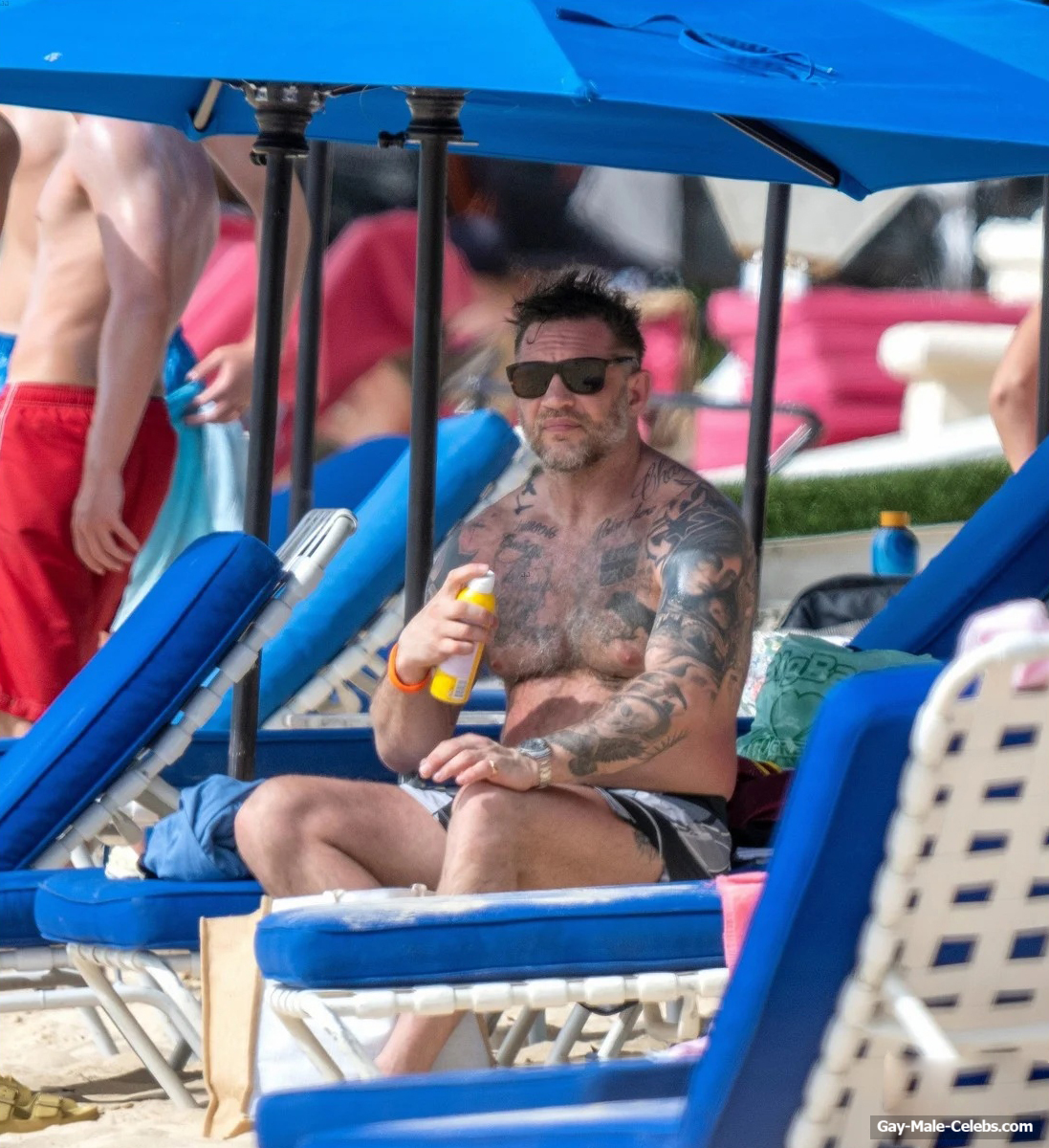 Tom Hardy shirtless on a beach