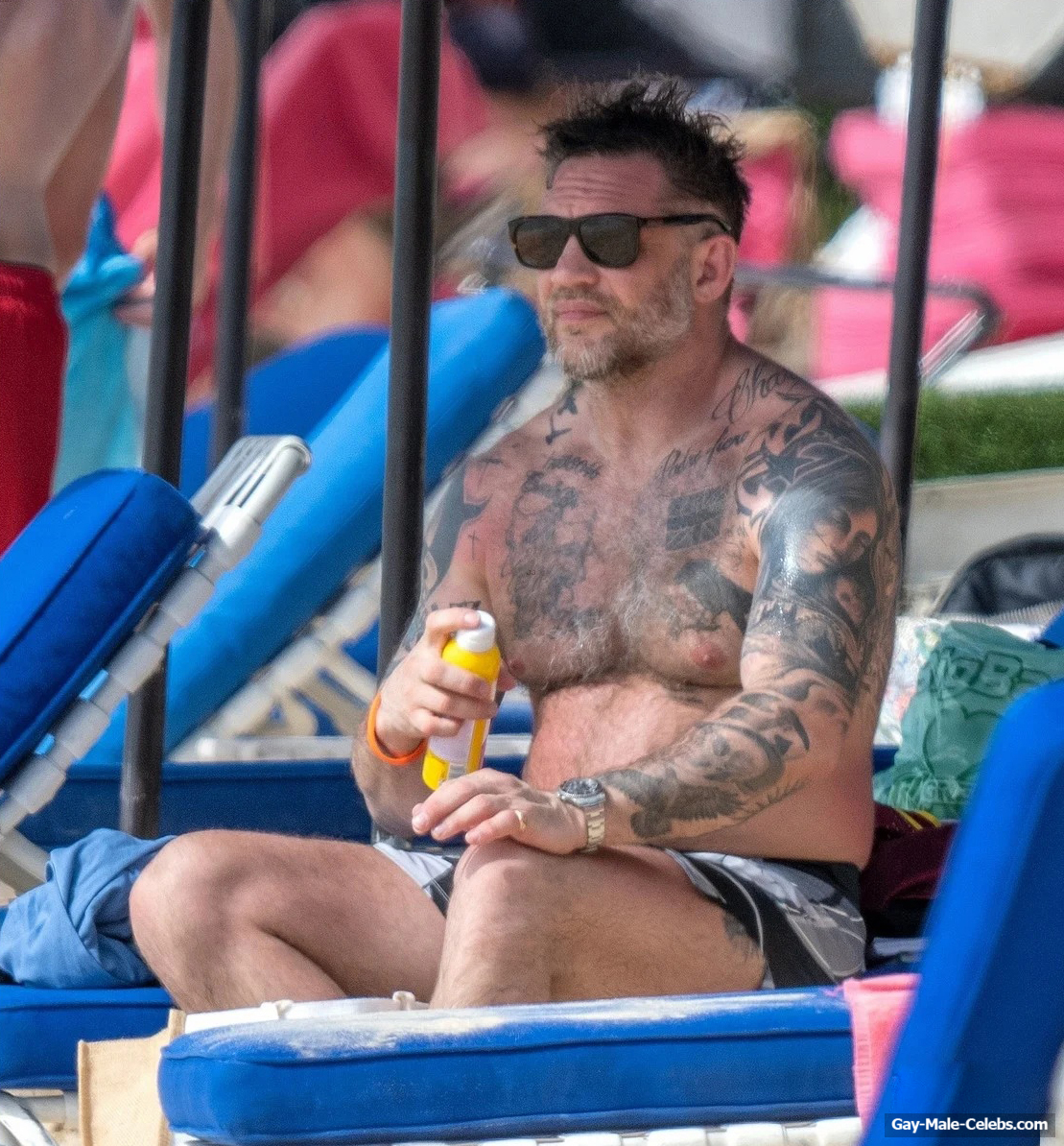 Tom Hardy shirtless on a beach